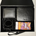 Gift set with black leather wallet, black leather pouch, and chocolate bar in a 'GIFTED LONDON' box.