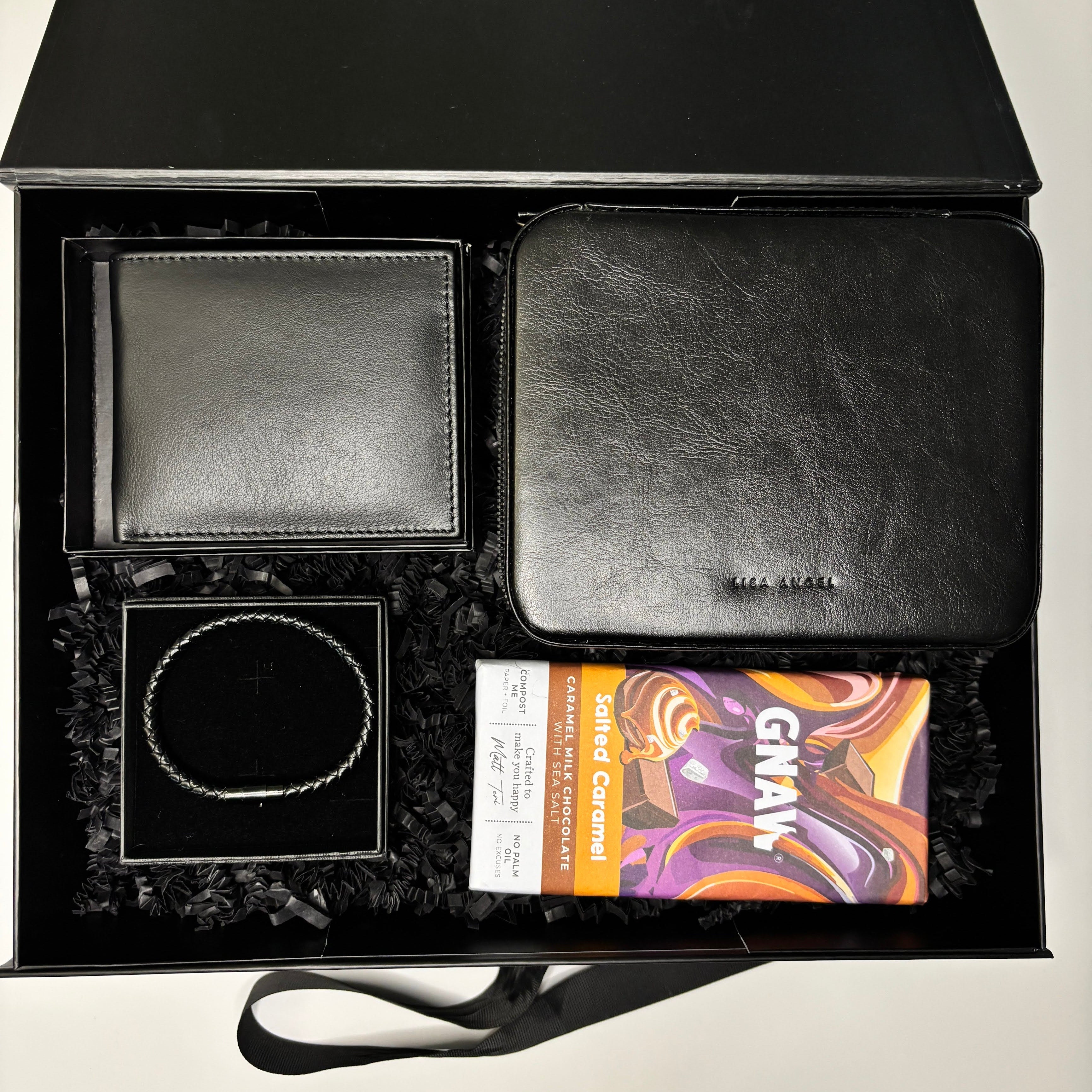 Gift set with black leather wallet, black leather pouch, and chocolate bar in a 'GIFTED LONDON' box.